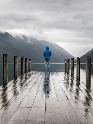 Man standing on wet dock